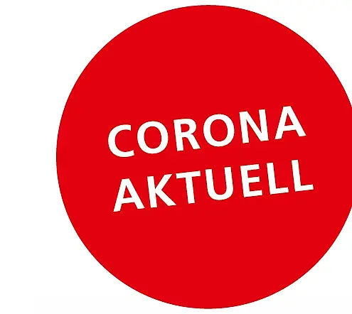 Ein roter Kreis mit dem Text „CORONA AKTUELL“ in weißer Schrift. Der Text ist prominent und informiert über aktuelle Informationen zu Corona.