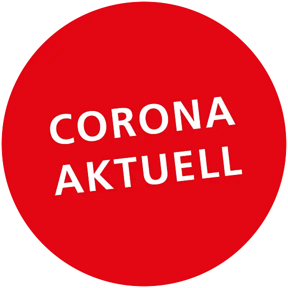 Runder roter Hintergrund mit dem Text "CORONA AKTUELL" in weißer Schrift.